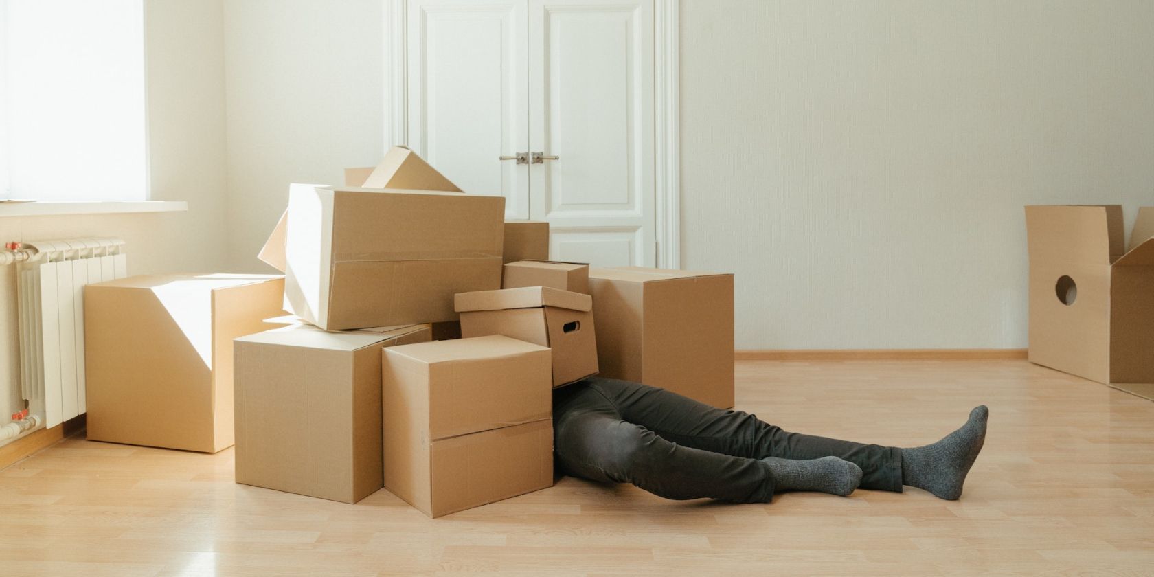 a person buried under a pile of boxes