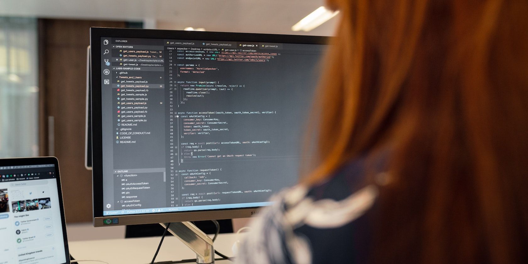 Backview of person coding on computer