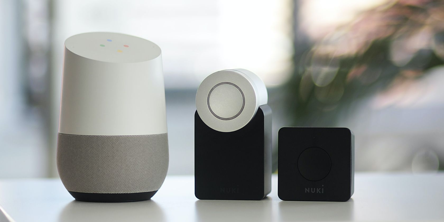 Google Home and Nuki Smart Lock sitting on table