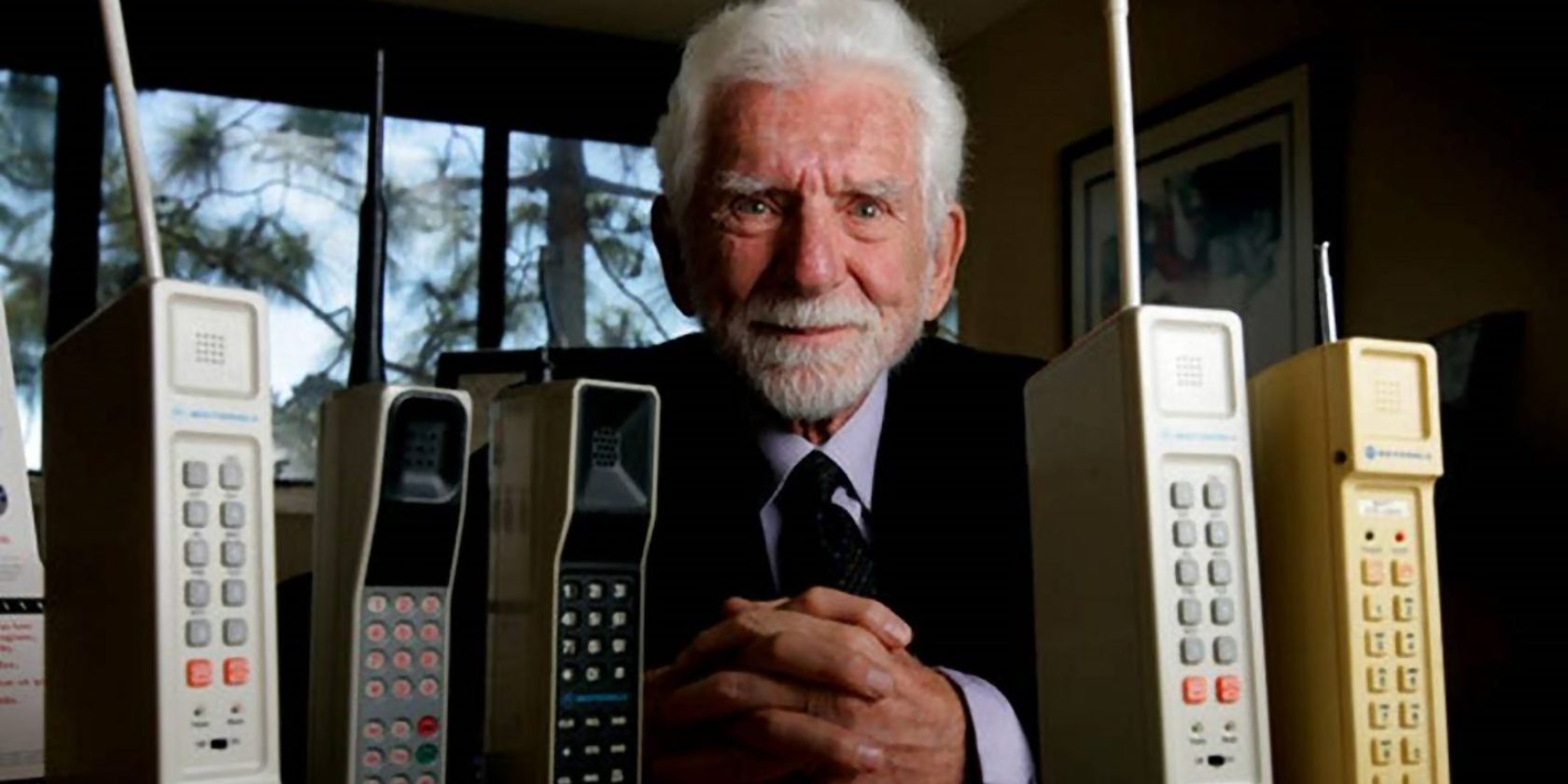 Father of the cell phone Martin Cooper posing with the DynaTAC 8000X