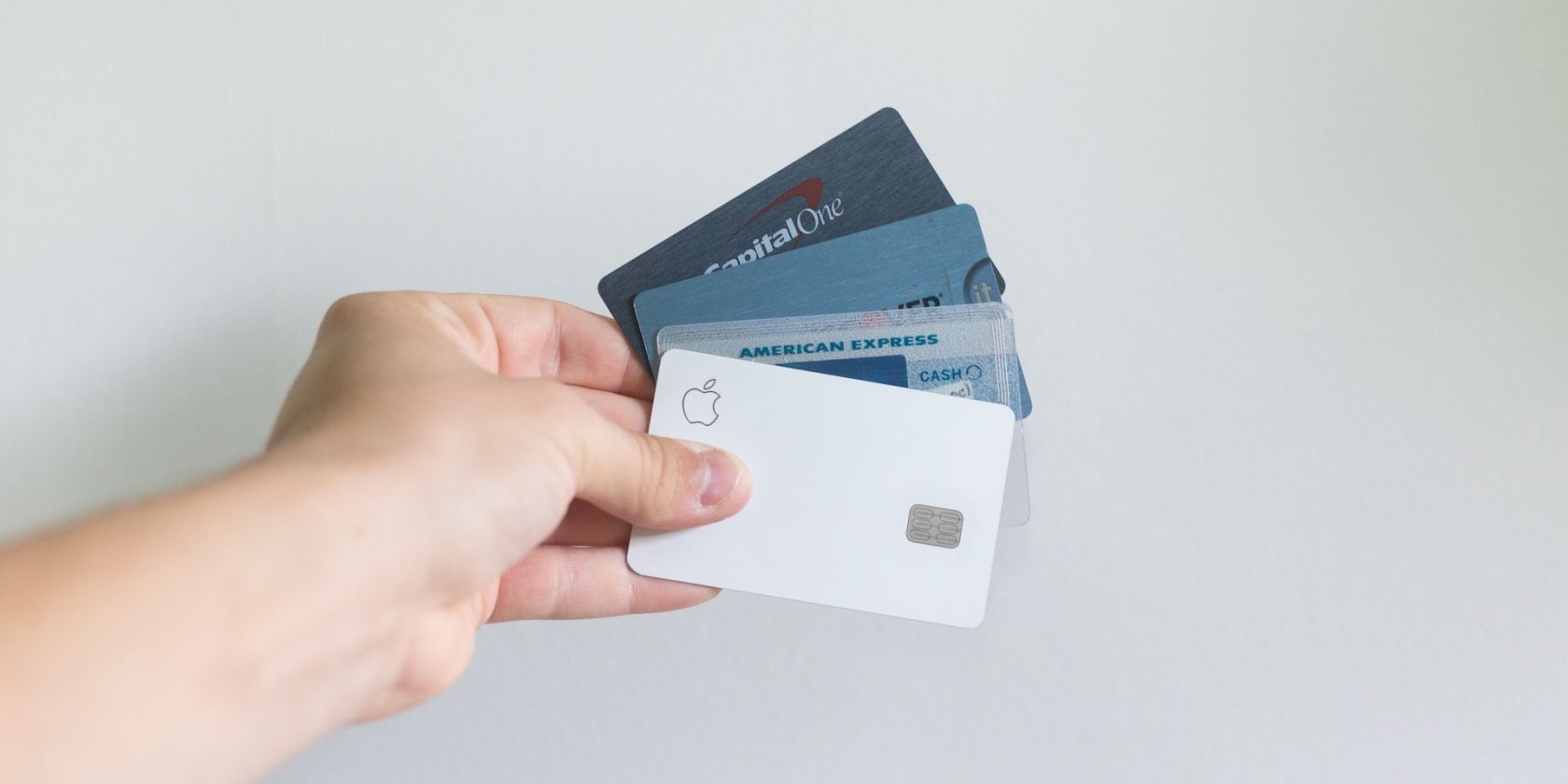Apple Card and credit cards in hand