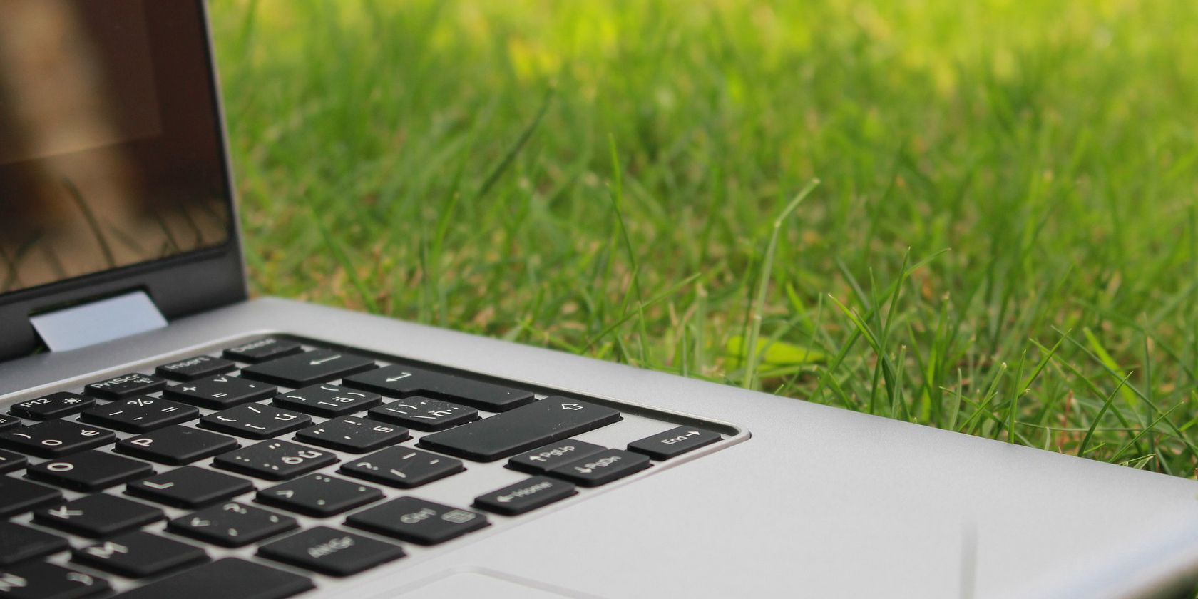 Picture of laptop sitting on grass