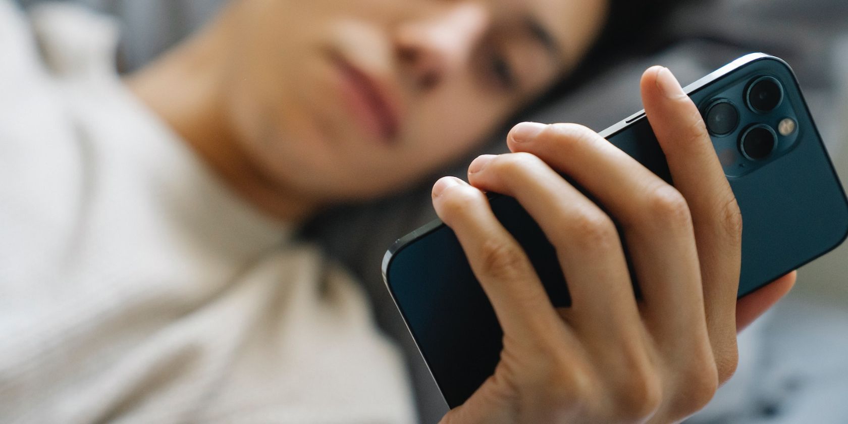 Man using a smartphone after waking up