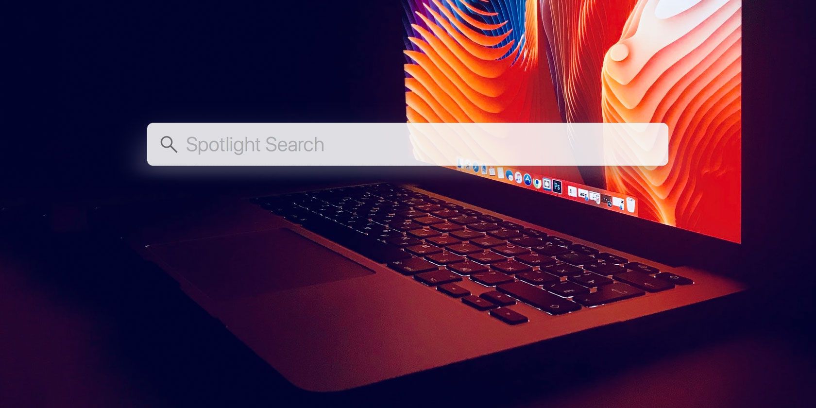 6 mẹo nếu Spotlight trên máy Mac của bạn không tìm nạp kết quả tìm kiếm mong muốn Spotlight search bar in front of a MacBook