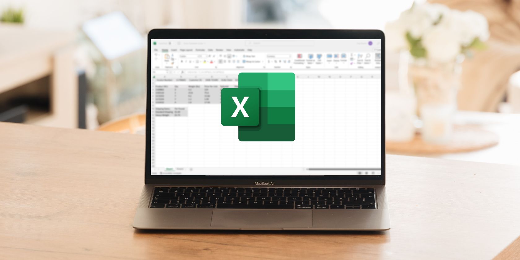 A Laptop Sitting On Top of a Wooden Table. An Excel Spreadsheet Is Blurred Out in the Background, and the Excel Logo is in the Foreground