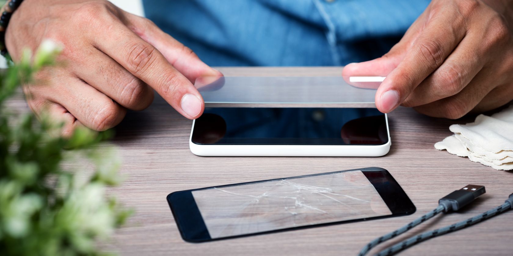 man applying screen protector to smartphone feature