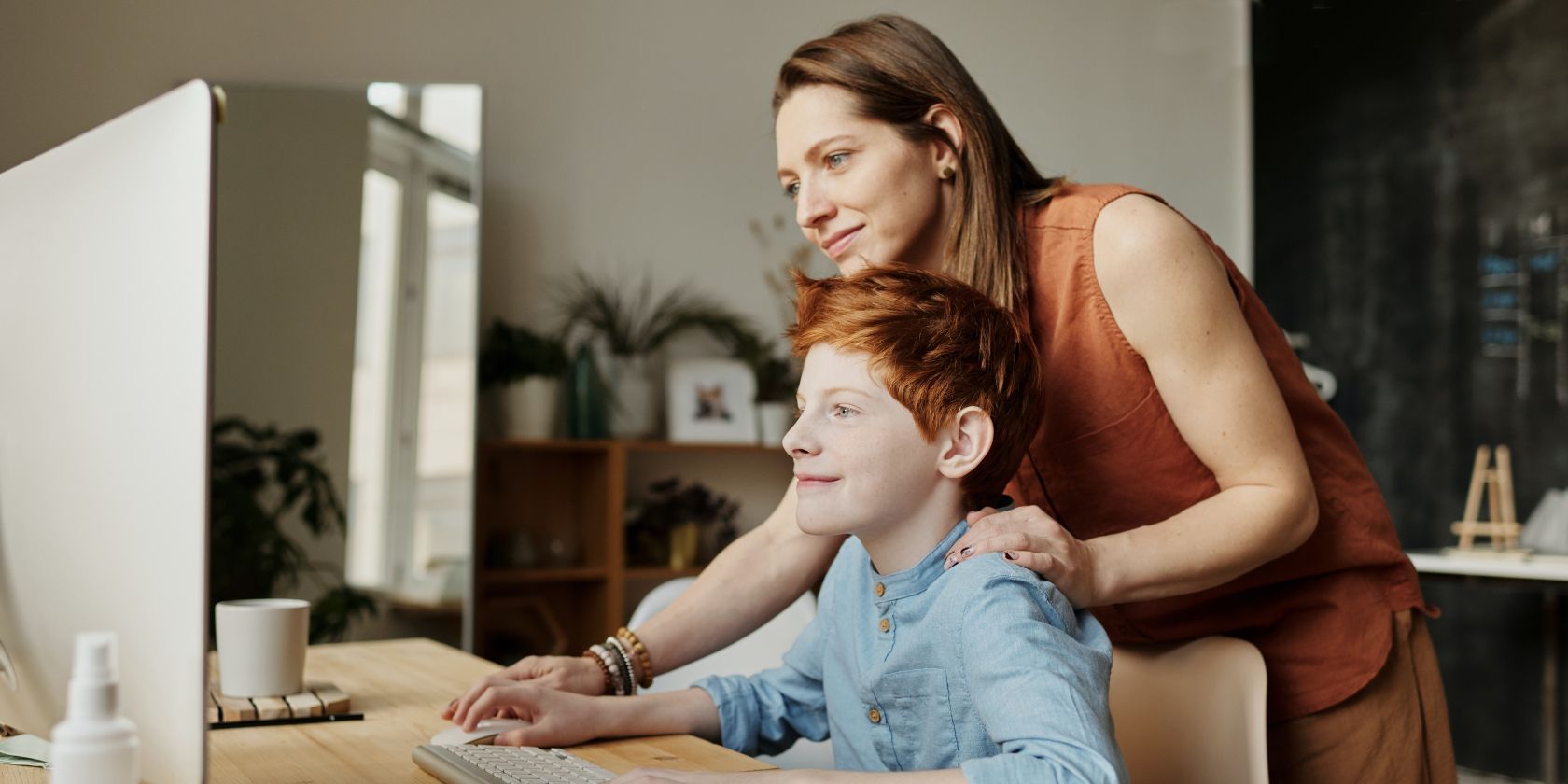 Mother and son learning on a computer