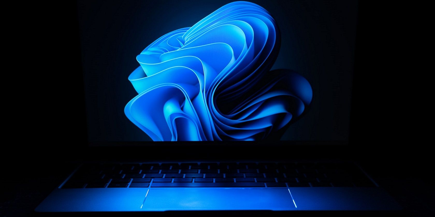 A laptop with Windows 11 desktop wallpaper