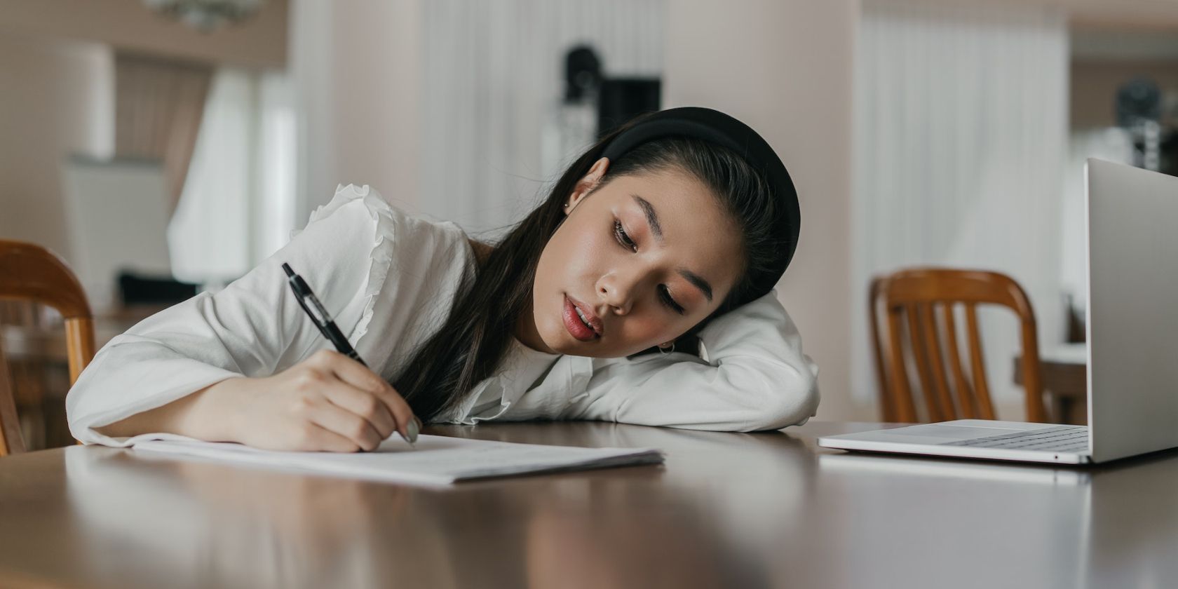Writer Using Notebook and Laptop