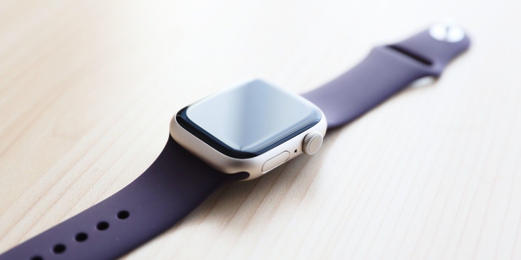 Close-up of Apple Watch with black band sitting on table