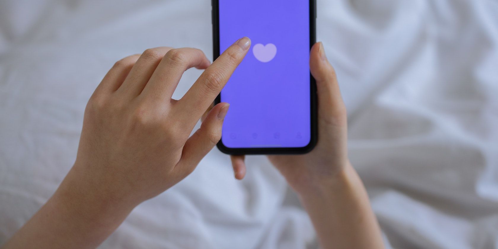 hand swiping on a dating app open on a smartphone