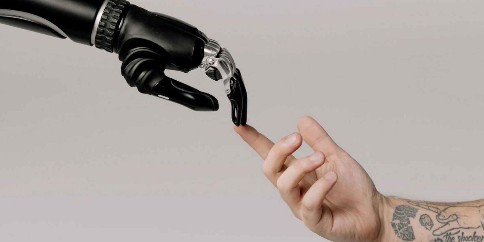 Human hand touching the bionic hand
