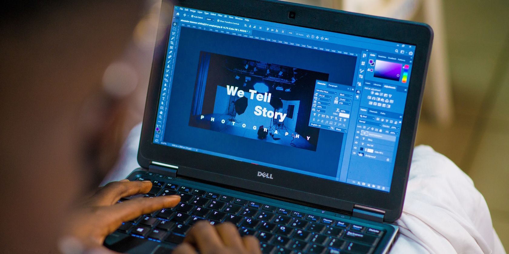 A person designing something in Photoshop.