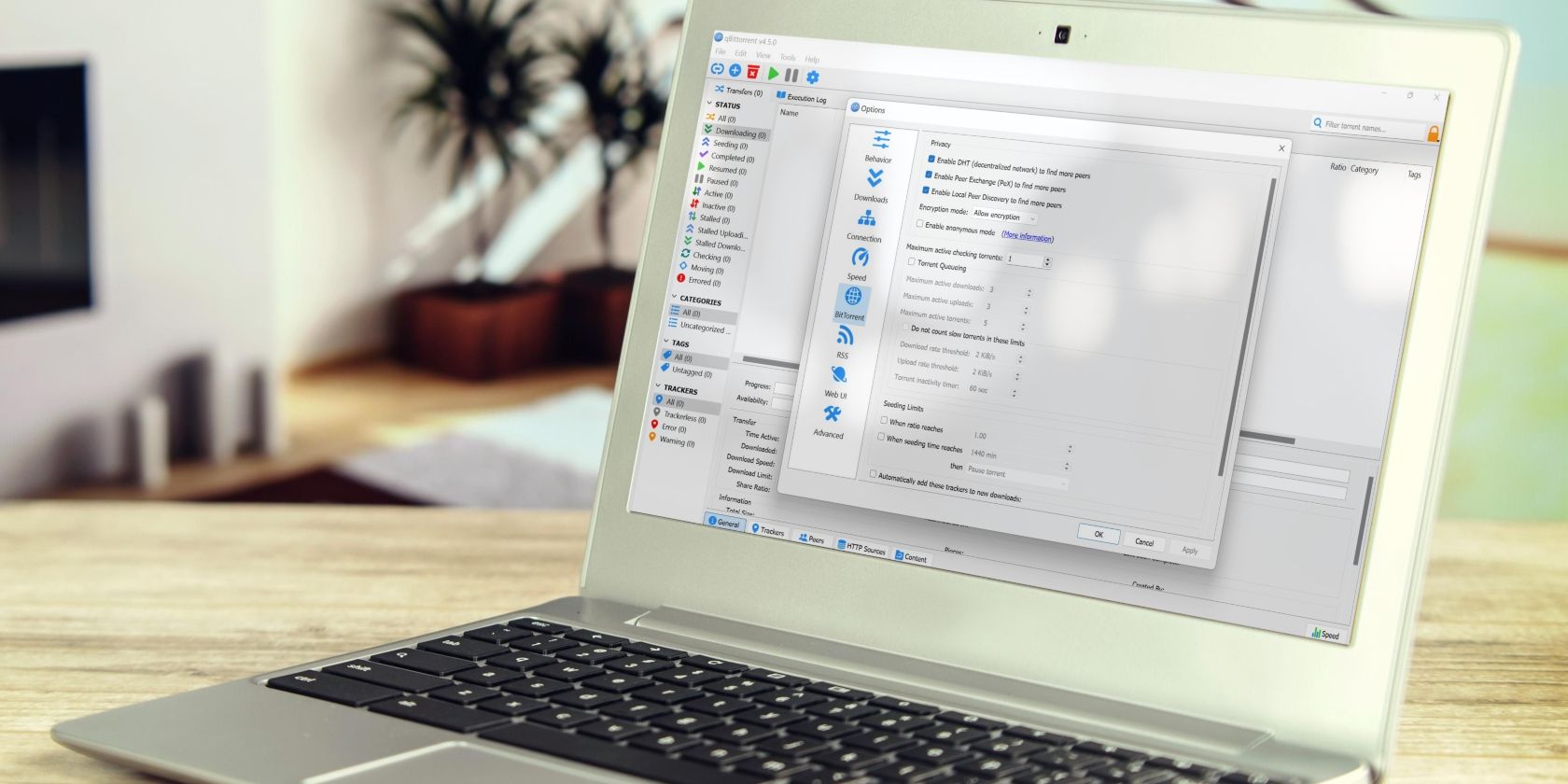 qBittorrent Client Open in a Laptop Placed on a Table