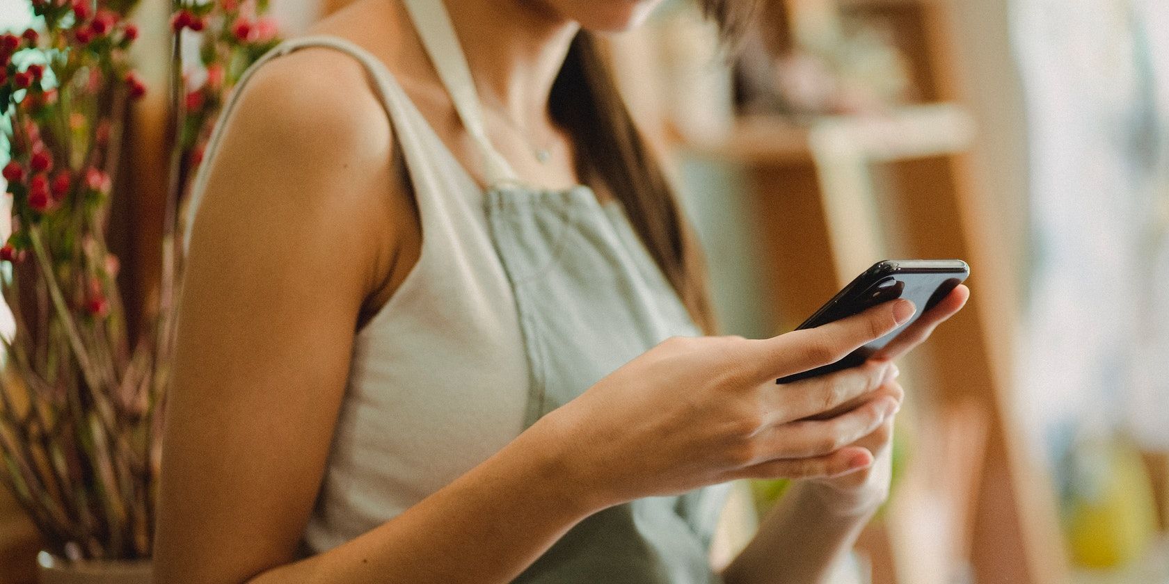 Woman using a phone in a shop